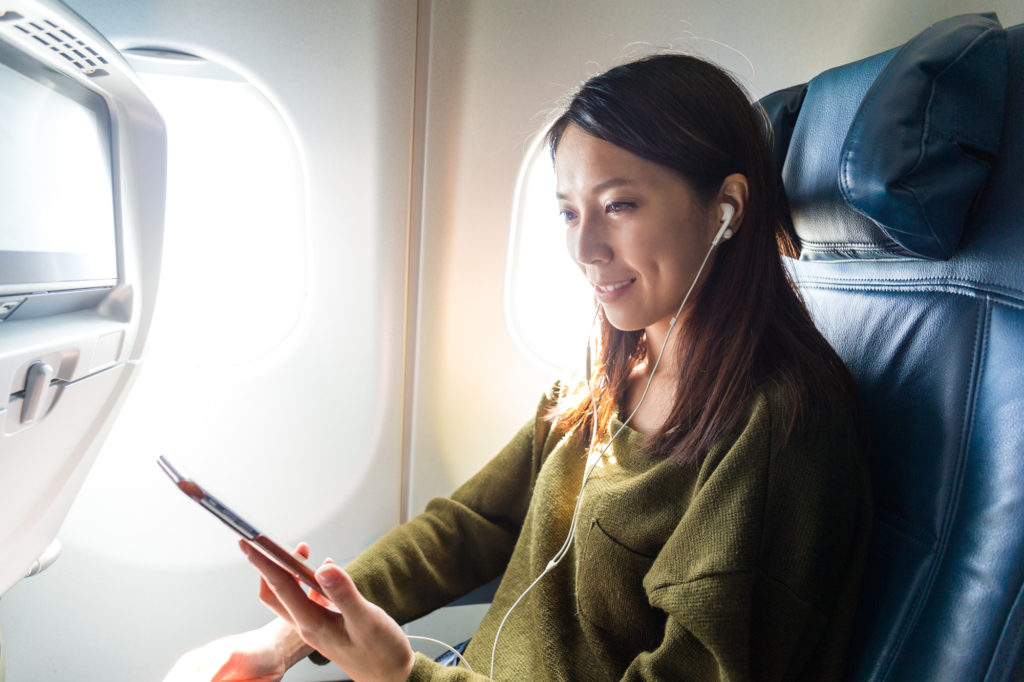 Woman Listening to Music While Traveling